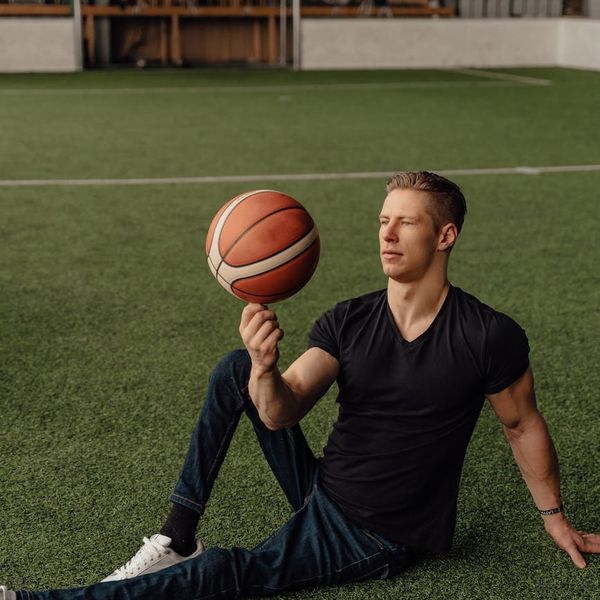 Man holding a difficult balance pose, showing focus and control.